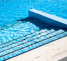 Stairs clear blue swimming pool