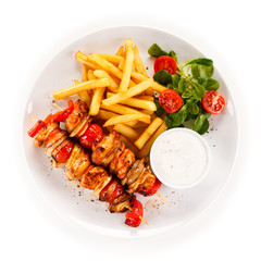 Kebab - grilled meat and vegetables on white background
