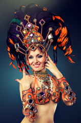 Fototapeta premium Beautiful slender dancer , belly dance in motion in a colorful costume .Dancer in motion in carnival costume 