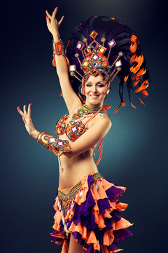 Beautiful slender dancer , belly dance in motion in a colorful costume  .Dancer in motion in carnival costume
