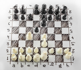 Chess. White board with chess figures on it. Plan of battle.