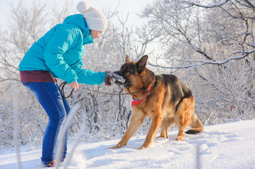 Girl trains her dog German Shepherd