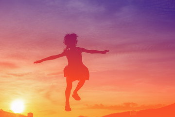 Fototapeta na wymiar Girl jumping during sun set, colour filter effect.