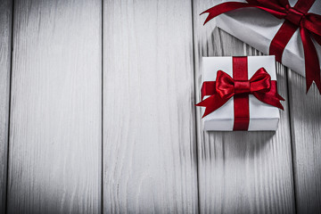 Gift boxes with tied bows on wooden board holidays concept