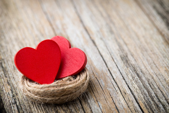 Red heart-shaped on a wooden background.