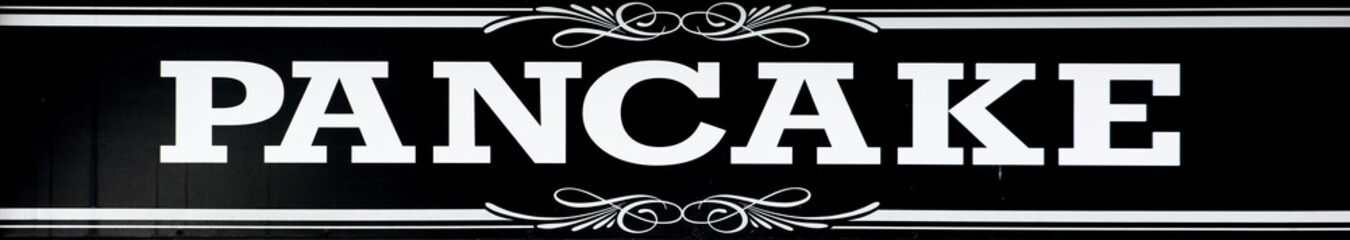 Sign at a Carnival kiosk advertising Pancakes