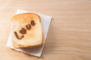 Love message on Bread sliced on wooden background.