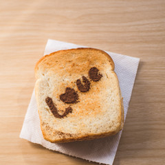 Love message on Bread sliced on wooden background.