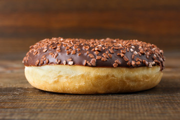 yummy donut with chocolate on brown wood table