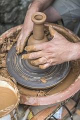 Potter makes clay bottle