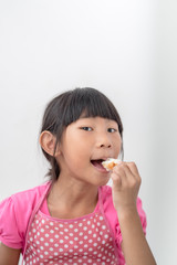 Asian girl eating bread at home.