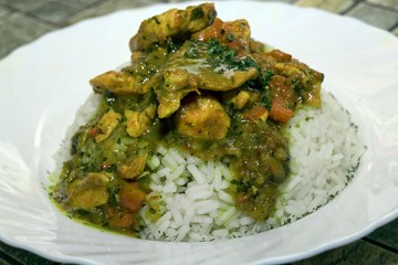 Curry chicken with coconut milk and rice on plate