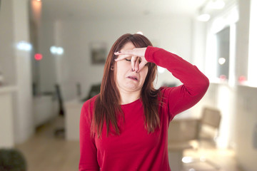 Young girl holding her nose