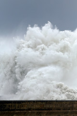 Huge stormy sea wave over pier