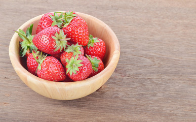 Ripe red strawberries on wooden table