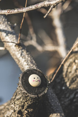 Smile icon miniature on tree