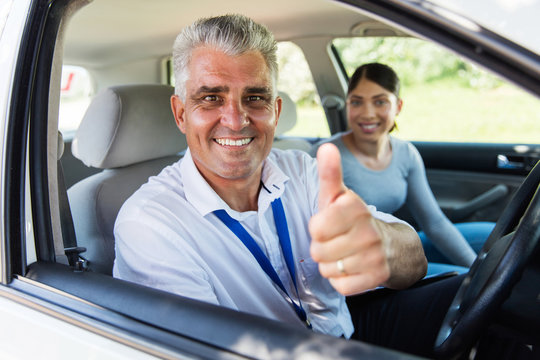 senior driving instructor giving thumb up