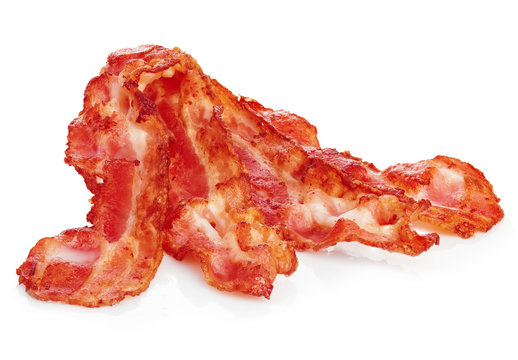 Cooked bacon rashers close-up isolated on a white background.