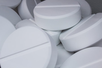 Macro shoot of pile of white pills.