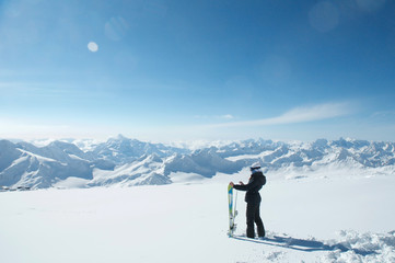 Fototapeta na wymiar Side view of skier looking at snow covered mountains.