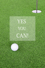 Golf ball and hole with word yes you can for inspiration