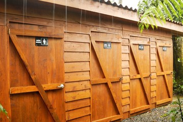 Line of Toilet doors in the rain