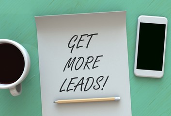 Get More Leads, message on paper, smart phone and coffee on table
