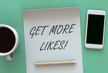 Get More Likes, message on paper, smart phone and coffee on table