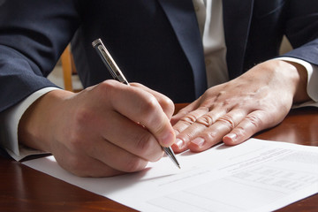 Businessman's hand signing papers. Lawyer, realtor, businessman 