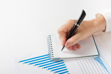 Businessman counting losses and profit working with statistics, analyzing financial the results on white background. Copy space