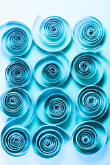 Macro, abstract, background picture of blue paper spirals on paper background 