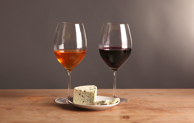 Refined still life of wine and cheese on wooden table