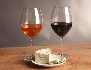 Refined still life of wine and cheese on wooden table