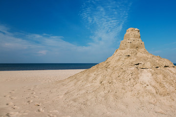 Sand castle on the beach. Ruins, seashore