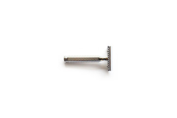 vintage chrome plated razor on a white background seen from above