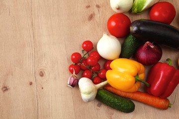 Composition with assorted raw organic vegetables wooden table