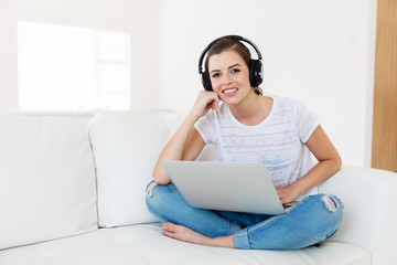 young woman with headphones and laptop