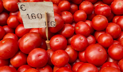 Fresh tomatoes in a market stall.