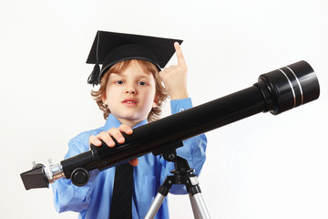 Young astronomer in academic hat with telescope on a white background