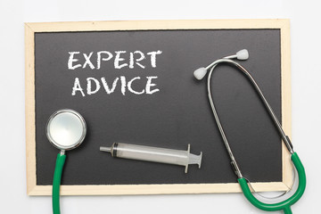 EXPERT ADVICE concept with stethoscope and syringe