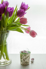 Chocolate Mini eggs next to tulips