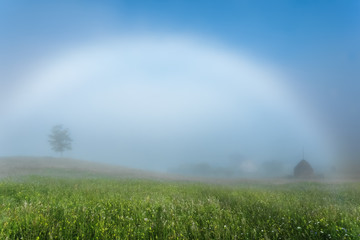 Naklejka premium Carpathian Mountains. White rainbow in the mist.