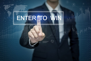 Businessman hand touching ENTER TO WIN button on virtual screen