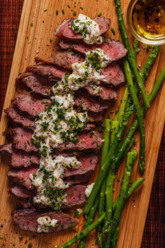 Steak with blue cheese sauce served with asparagus.