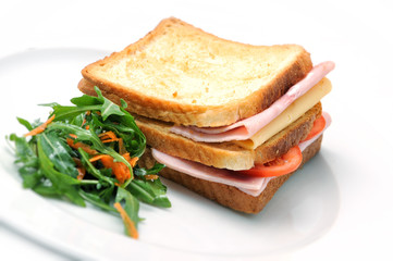toast sandwich with ham, cheese, tomatoes and salad on white plate, isolated on white background