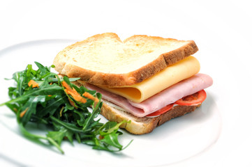 toast sandwich with ham, cheese, tomatoes and salad on white plate, isolated on white background