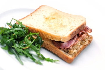 toast sandwich with ham, cheese, onion and salad on white plate, isolated on white background