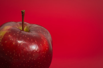 Red apple on the red background