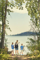 Family on a day hike together near a beautiful mountain lake