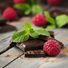 Dark chocolate with mint and raspberry on the vintage table